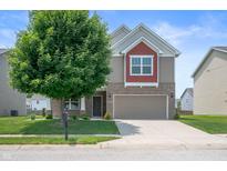 Charming two-story home featuring a well-manicured lawn and attached two-car garage at 2324 Boneset Dr, Plainfield, IN 46168