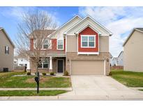 Charming two-story home with a brick and siding exterior, attached garage, and well-maintained lawn at 2324 Boneset Dr, Plainfield, IN 46168