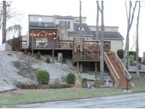 Charming multi-level home featuring a spacious wooden deck, stone accents and landscaped grounds at 269 Iron Bridge Rd, Cicero, IN 46034