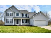 Charming two-story home featuring a well-manicured lawn, attached garage, and classic architectural details at 269 Wakefield E Dr, Greenwood, IN 46142
