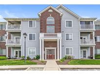 Three-story condo building with multiple balconies, brick accents, and well-maintained landscaping at 6231 Amber Creek Ln # 312, Indianapolis, IN 46237