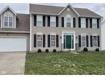 Charming two-story home featuring a green front door, black shutters, and well-manicured lawn at 6816 Russett Dr, Plainfield, IN 46168