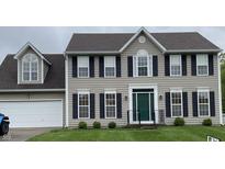 Charming two-story home with gray siding, black shutters, well-maintained lawn, and a two-car garage at 6816 Russett Dr, Plainfield, IN 46168