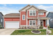 Charming two-story home with a red exterior, stone accents, and a well-maintained lawn at 7254 Cambridge Pl, Avon, IN 46123