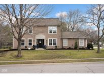 Charming two-story home featuring a landscaped yard, classic siding, and a welcoming front entrance at 7383 Poppyseed Dr, Indianapolis, IN 46237