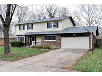Charming two-story home with a brick and siding exterior, attached two car garage, and a well-manicured front yard at 8151 Taunton Rd, Indianapolis, IN 46260