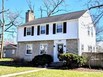 Charming two-story home with a stone facade, black shutters, and a well-maintained front yard at 1225 16Th St, Columbus, IN 47201