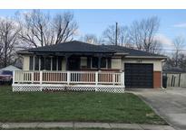 Cozy home featuring a charming front porch, well-manicured lawn, and convenient one-car garage at 127 Brunswick Dr, Greenwood, IN 46143
