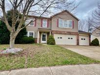 Charming two-story home with a well-maintained lawn and a two-car garage at 1426 Ripplewood Dr, Danville, IN 46122