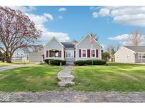 Charming single-Gathering home with a well-manicured lawn and patriotic American flag at 1617 S N St, Elwood, IN 46036