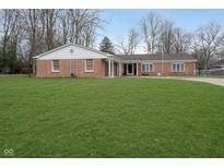 Charming brick ranch-style home featuring a well-manicured front lawn and a welcoming entrance at 2315 Starlight Dr, Anderson, IN 46012