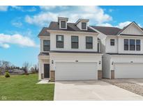 Beautiful two-story home featuring white siding, black-trimmed windows, and an attached two-car garage at 3308 Morab Dr, Zionsville, IN 46077