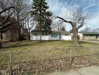 Charming single-story home featuring a well-maintained lawn and mature trees in a suburban setting at 4224 N Arlington Ave, Indianapolis, IN 46226