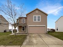 Charming two-story home with neutral siding, attached garage, and well-manicured lawn at 10719 Crackling Dr, Indianapolis, IN 46259