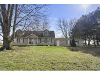 Charming two-story home featuring green shutters and a spacious front yard on a sunny day at 11686 S 825 W, Edinburgh, IN 46124
