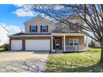 Charming two-story home featuring brick accents, a welcoming porch, and a well-manicured front lawn at 1215 Wild Ridge Blvd, Brownsburg, IN 46112