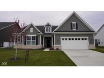 Charming home featuring gray siding, white trim, and a well-manicured front lawn and a two car garage at 1274 Clairet, Westfield, IN 46074