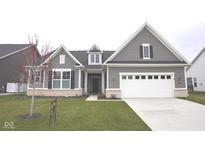 Charming, gray, two-story home with a well-manicured lawn and attached two-car garage at 1274 Clairet, Westfield, IN 46074