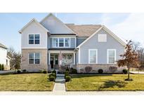 Charming two-story home featuring a well-maintained lawn and a welcoming front porch at 12889 Copper Run Blvd, Carmel, IN 46074