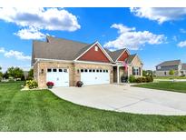 A beautiful home with manicured lawn and landscaping, and a three-car garage at 1684 Beach St, Greenwood, IN 46143