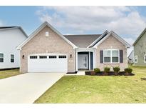 Charming brick home with a two-car garage, well-maintained lawn and nice landscaping at 1803 Jackson St, Fortville, IN 46040