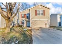 Inviting two-story home featuring red shutters, a two-car garage, and a well-maintained front yard at 1847 Dutch Elm Dr, Indianapolis, IN 46231