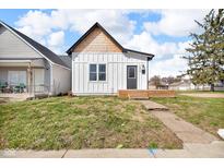 Charming home featuring vertical siding, cedar shake roof accent, and a compact front porch at 1854 Applegate St, Indianapolis, IN 46203