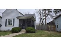 Charming home featuring a quaint screened-in front porch and tidy landscaping at 2028 George St, Anderson, IN 46016