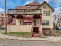 Charming two-story home featuring a spacious deck and a unique red trim at 2702 N Talbott St, Indianapolis, IN 46205