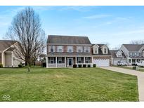 Charming two-story brick home featuring a well-manicured front lawn and attached two car garage at 3069 Autumn Run, Bargersville, IN 46106