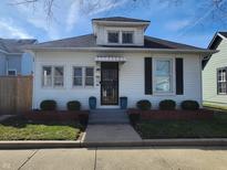 Charming white two-story home with a dormer window and well-maintained landscaping at 611 W South St, Shelbyville, IN 46176