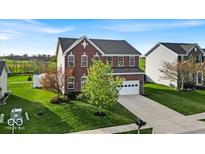 Beautifully landscaped two-story home with a brick facade, green lawn, and spacious driveway at 6862 School Branch Dr, Brownsburg, IN 46112