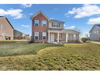 Charming two-story brick home with a covered front porch and well-maintained lawn at 7185 Laredo Dr, McCordsville, IN 46055