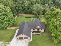 A beautiful aerial view of this home features a well-maintained lawn and a fenced backyard for outdoor enjoyment at 859 E Bunkerhill Rd, Mooresville, IN 46158