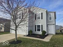 Charming two-story home with gray siding, black shutters, and a well-maintained front yard at 10915 Mansfield Way, Ingalls, IN 46048
