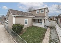 Charming two-story home with neutral siding, an inviting porch, and a well-maintained lawn at 1231 S Pershing Ave, Indianapolis, IN 46221