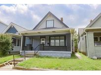 Charming home featuring a covered front porch and classic architectural details at 1715 Fletcher Ave, Indianapolis, IN 46203