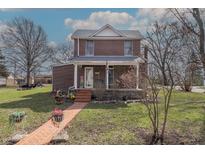 Charming two-story brick home featuring a welcoming front porch and walkway at 241 S Walnut St, Jamestown, IN 46147