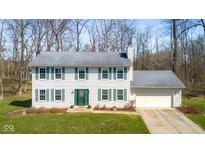 Charming two-story home with light siding, green shutters, well-manicured lawn, and an attached two-car garage at 2895 Prairie Stream Way, Columbus, IN 47203