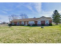Charming one-story brick home featuring large windows and a well-manicured lawn at 3451 N County Road 100 E, Danville, IN 46122