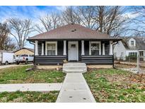 Charming home with a well-manicured front yard and a classic architectural design, columns, and sidewalk entrance at 3940 N Drexel Ave, Indianapolis, IN 46226
