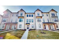 Inviting townhome exterior with a manicured lawn and neutral tones, complete with a charming walkway at 4271 Barrel Ln, Westfield, IN 46062