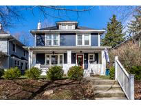 Charming two-story home with a red door, inviting front porch, and well-manicured landscaping at 4350 N College Ave, Indianapolis, IN 46205
