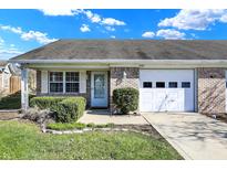 Charming single-story brick home featuring an attached garage and manicured landscaping at 5737 Misty Ridge Cir, Indianapolis, IN 46237