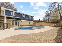 Backyard showcasing the in-ground pool, brick patio, and a privacy fence at 649 W Banta Rd, Indianapolis, IN 46217