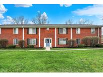 Charming brick townhome with a well-manicured lawn and inviting blue front door at 6515 Park Central Way # B, Indianapolis, IN 46260