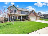 Charming two-story home with a well-manicured lawn and mature trees at 7233 Capel Dr, Indianapolis, IN 46259