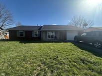 Charming single-story home boasts a well-maintained lawn and a classic brick facade at 731 W Stop 11 Rd, Indianapolis, IN 46217