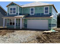 Two-story home with an attached two-car garage in the early stages of construction with a gravel and dirt yard at 7549 Big Bend Blvd, Camby, IN 46113