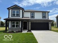 Charming two-story home featuring black trim, a stone garage, and a well-manicured lawn at 7549 Big Bend Blvd, Camby, IN 46113